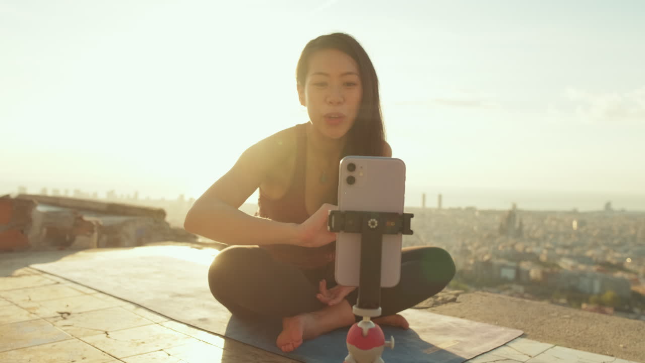 Woman practicing yoga outdoors at sunrise