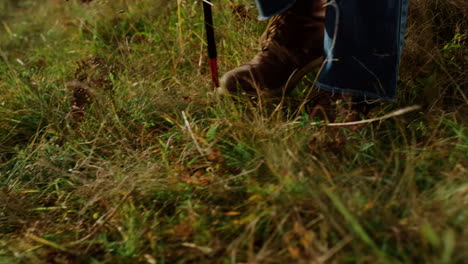 closeup legs travel mountains outdoors. hiker feet wear trekking boots on walk.