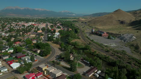 Aerial-cinematic-drone-mid-summer-downtown-Salida-S-Colorado-near-Buena-Vista-on-Arkansas-River-Riverside-Park-Scout-surfing-wave-mountain-biking-hiking-rafting-Rocky-Mountain-forward-pan-up-movement