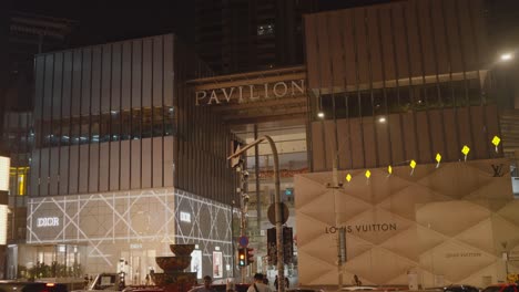 profile view of pavilion shopping mall with luxury brands at kuala lumpur, malaysia during night.