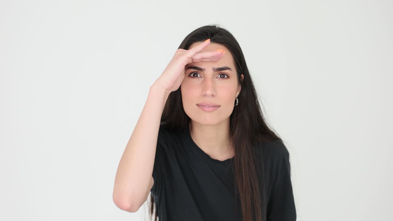 Woman saluting and looking seriously