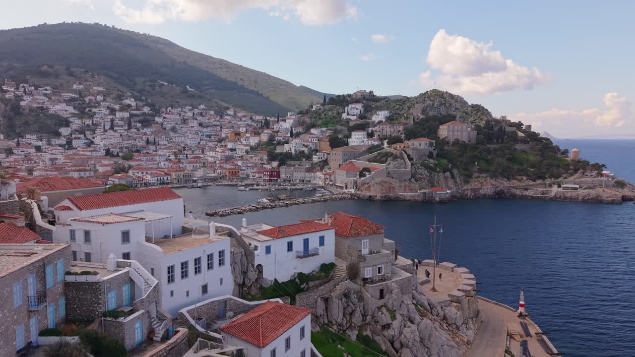 Cinematic drone footage reveals the port of Hydra starting from the statue of Admiral Miaoulis. A historic tribute opens to breathtaking views of the harbor and island charm