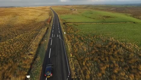 aerial tracking of car on scottish countryside road