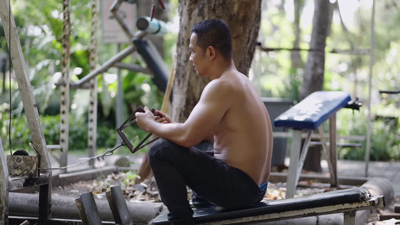 Man exercising on outdoor gym equipment