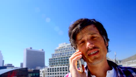 male photographer talking on mobile phone in the terrace 4k