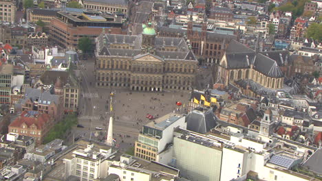aerial establishing shot of the royal palace in downtown amsterdam in dam square