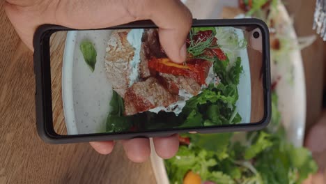 taking a photo of a salad sandwich