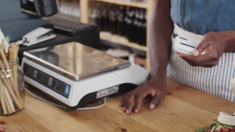 close up of customer making contactless payment for shopping at checkout of grocery store