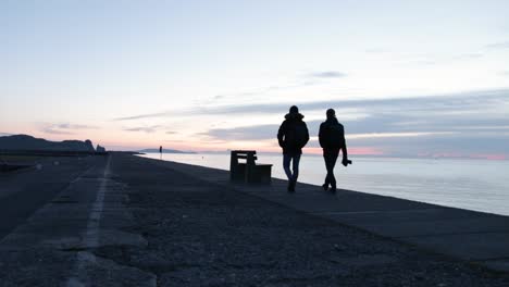two photographers walking together to their location to photograph the sunrise at howth