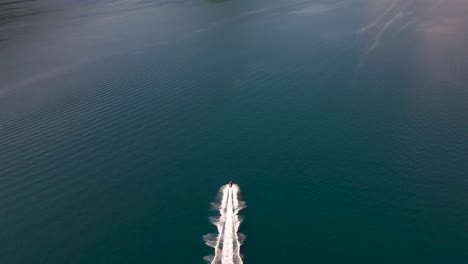 cinematic aerial video of navigating speed boat in the bay of kotor at full speed