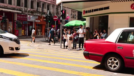 people and vehicles at a busy intersection