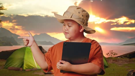 boy camping with tablet