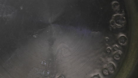 water is added to a pot on the stove, and as it heats, it begins to bubble