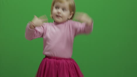 Happy-three-years-old-girl.-Cute-blonde-child.-Dancing-and-make-faces