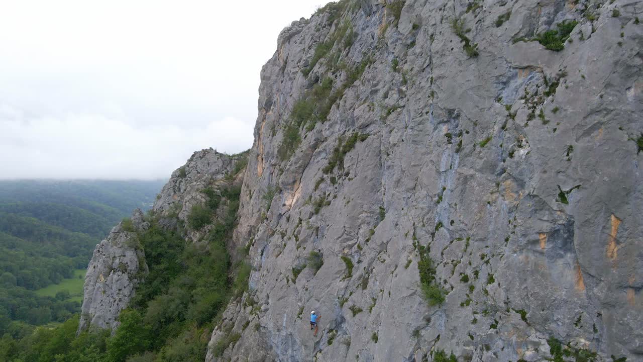 Distant drone footage of a man lead climbing in the Pyrenees moutains at Tarascon sur Ari&egrave;ge