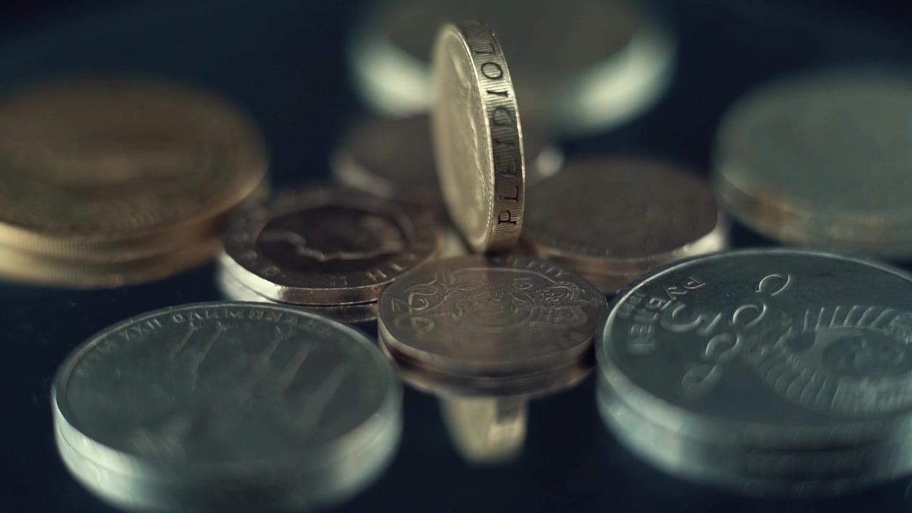 Macro video of vintage rare coins, retro money edition, old gold, on a rotating stand, 120 fps slow motion, tilt up movement