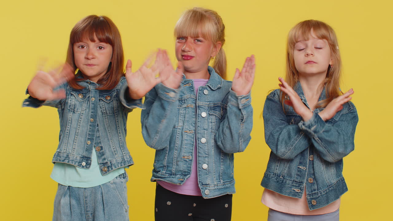 Three girls friends closing eyes with hand showing stop gesture confused shy scared to watch
