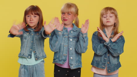 three girls friends closing eyes with hand showing stop gesture confused shy scared to watch