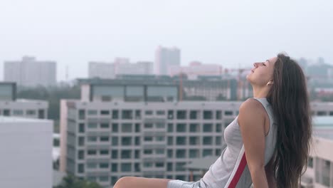 lady in knitwear dress sits on roof against beautiful view