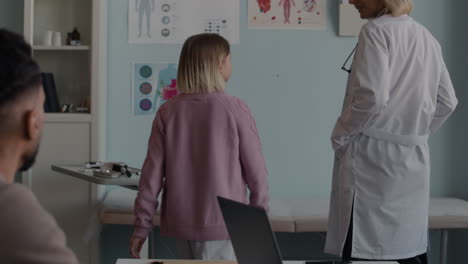 doctor examining a young patient in a clinic