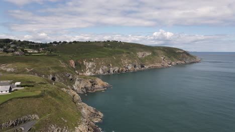 drone shot of cliffs over looking the ocean in dublin, ireland