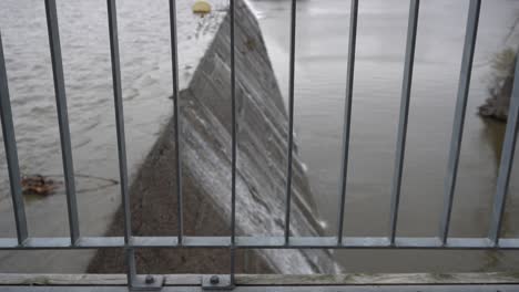 a close-up of the security fence where you can see the water dam