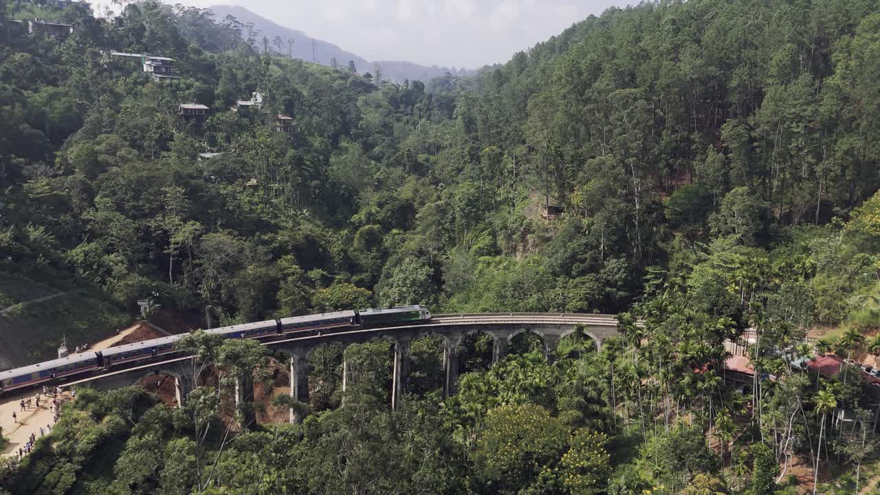 Fly towards nine arches bridge while the train is going over it, Sri Lanka