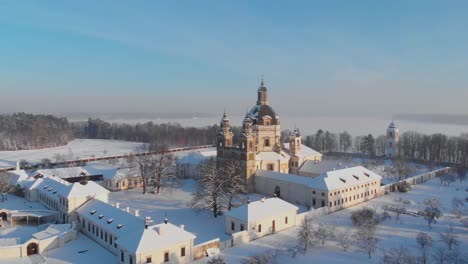 aerial view of the pazaislis monastery and the church of the visitation in kaunas, lithuania in winter, snowy landscape, italian baroque architecture, flying around the monastery, front side