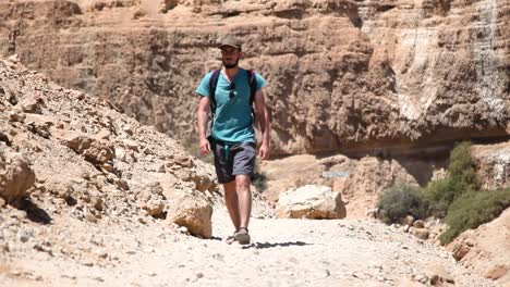 Adventurous-in-Mitzpe-Ramon,-Israel-pathway,-mountains-background,-static-shot