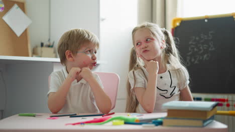 Boy-and-girl-look-at-each-other-and-nod-puffing-out-cheeks