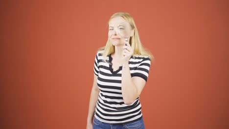 Woman-looking-at-camera-with-magnifying-glass.