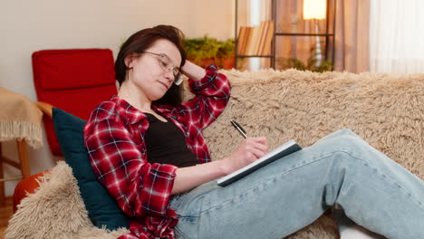 creative woman sketching in notebook at home focused inspired by creative process with calm energy