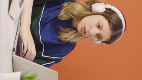 Vertical-video-of-The-young-woman-who-got-angry-at-what-she-saw-on-the-laptop.