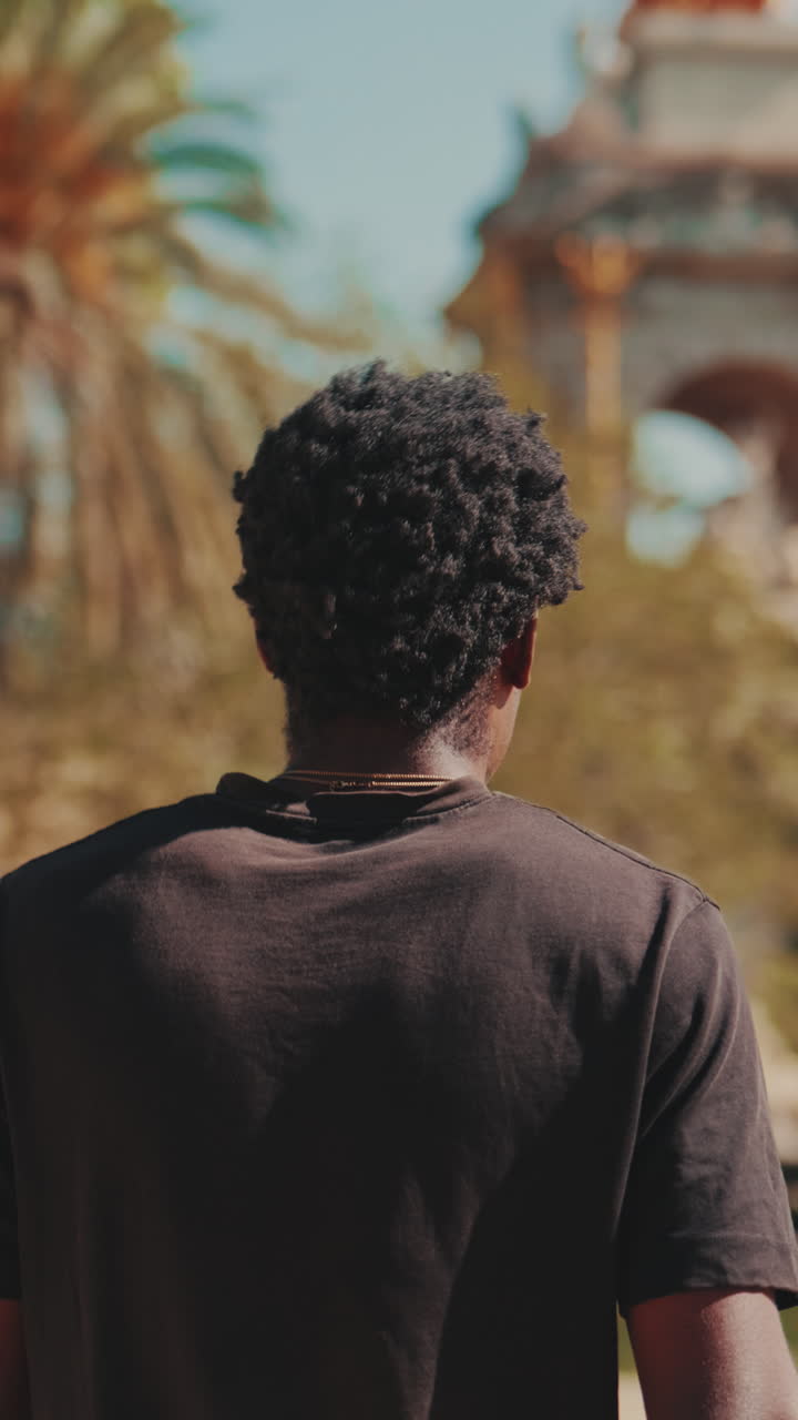 Young African American Man Walking in a Sunny Park