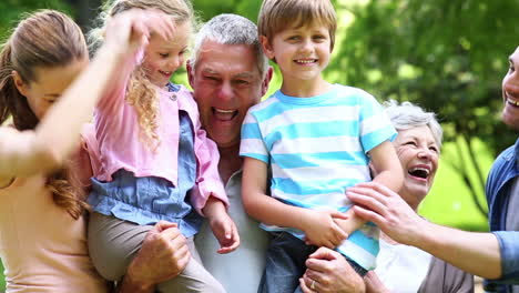 extended family standing in the park together posing