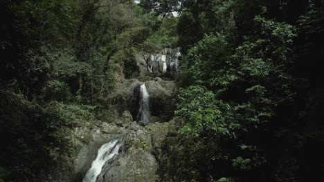 ascending aerial view of different levels of argyle waterfall in the caribbean rainforest of tobago