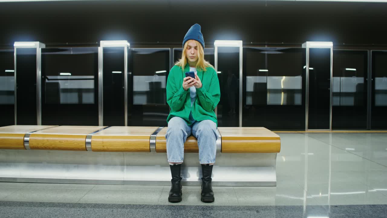 Woman using phone at subway station