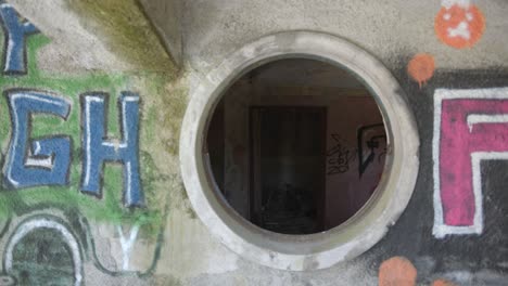 suspense, handheld dolly movement through a window inside of an abandoned building.