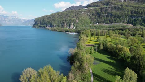 blend of beautiful blue waters,lush greenery at klontalersee lake,aerial