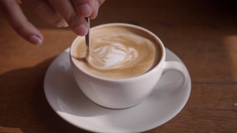 a white cup of latte art coffee