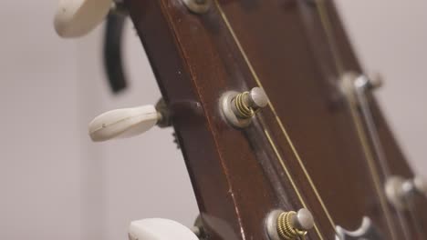 turning the tuning peg of a guitar