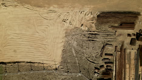 aerial flyover sandy field on construction site during hot summer day in pandemic