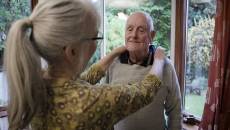 elderly man receiving assistance from caregiver