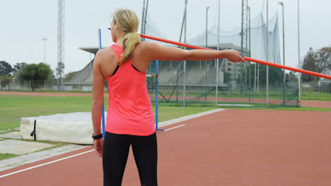 rear view of caucasian female athlete getting ready for javelin throw at sports venue 4k