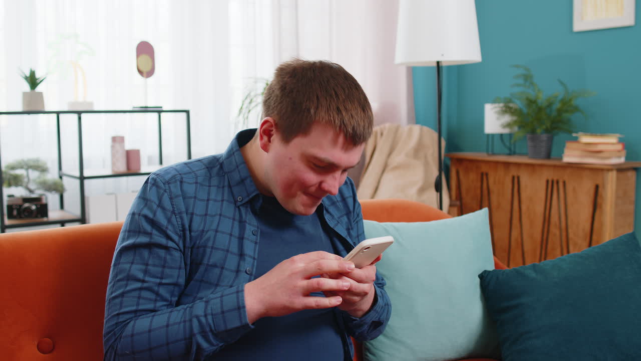 Surprised excited man holding smartphone reading good news amazed by online bet bid game win victory