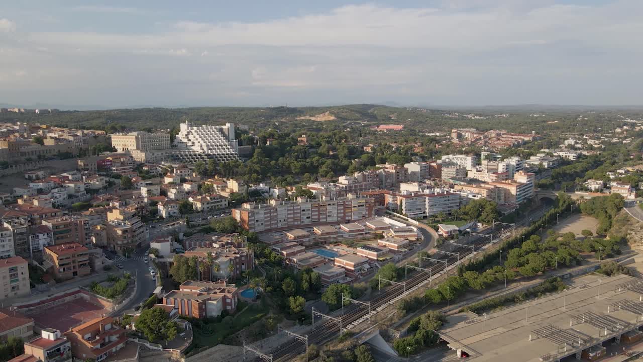 A breathtaking circular drone view of the ancient Roman outpost in Tarragona, Spain, bathed in the warm glow of the sunset