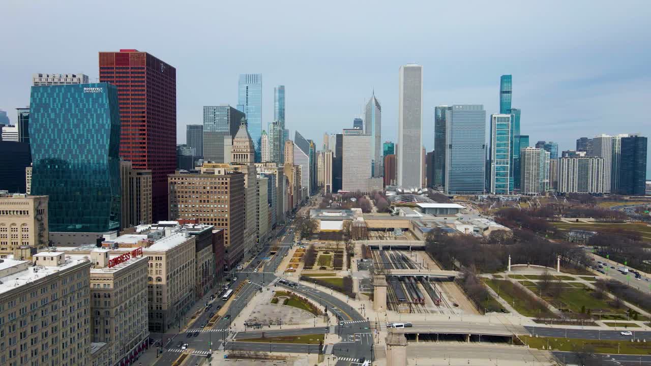 aerial footage captures skyline of downtown Chicago from a bird's-eye view. The sprawling cityscape and towering skyscrapers are full of grandeur energy related to architecture, tourism and cityscapes
