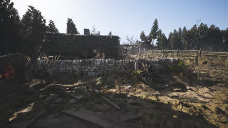 abandoned rural landscape with ruined stone wall and vintage wagon wheel