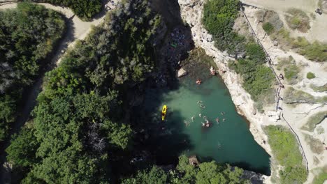 People-swimming-in-Sorrento,-in-a-hidden-beach-called-Regina-Giovanna-baths