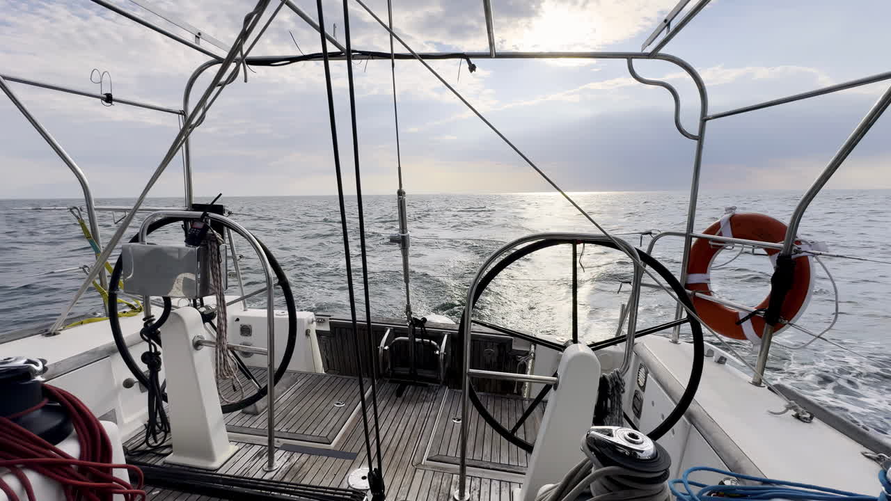 View from the Helm of a Sailboat Cutting Through the North Sea's Calm Waters Under a Soft, Overcast Sky, Captured from a Central Cockpit Perspective Navigating the Grey Expanse